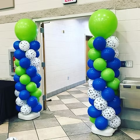 Balloon pillars in blue, green, and white set up for delivery by Blue Luna Events in Tucson event styling tucson balloon decor